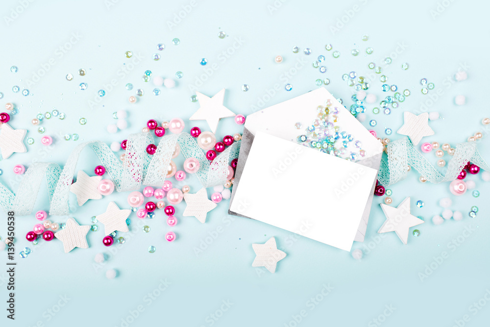 Envelopes with empty card on blue background with with cute decoration: heart, lace ribbon, stars and sequins. Flat lay, top view Envelopes with empty card on blue background with with cute decoration: heart, lace ribbon, stars and sequins. Flat lay, top view
