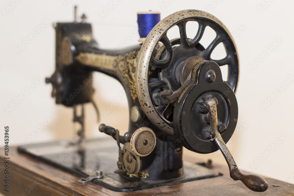 Vintage isolated sewing machine with spool of thread