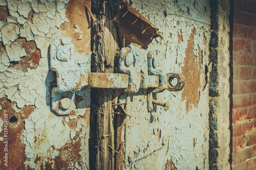 Old antique door with chipped paint and rusted lock. Macro shot.
