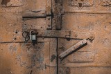 Old antique door with chipped paint and rusted lock. Macro shot.
