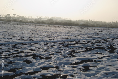 frozen field with snow in the winter photo