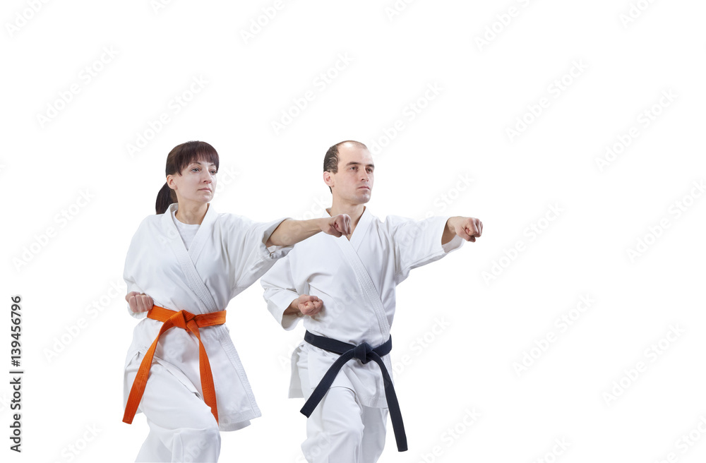 With black belt and orange belt the athletes are beating punch arm