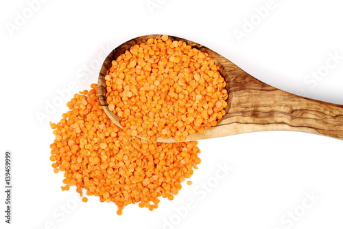 pile red lentils in wooden spoon isolated on white, top view 