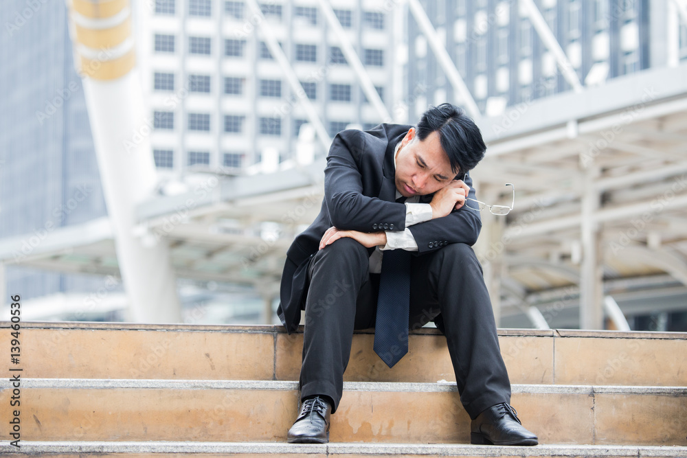 Asia businessman sleeping at city.