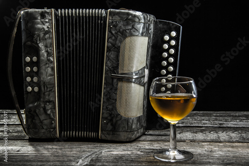 Old accordion with wine photo