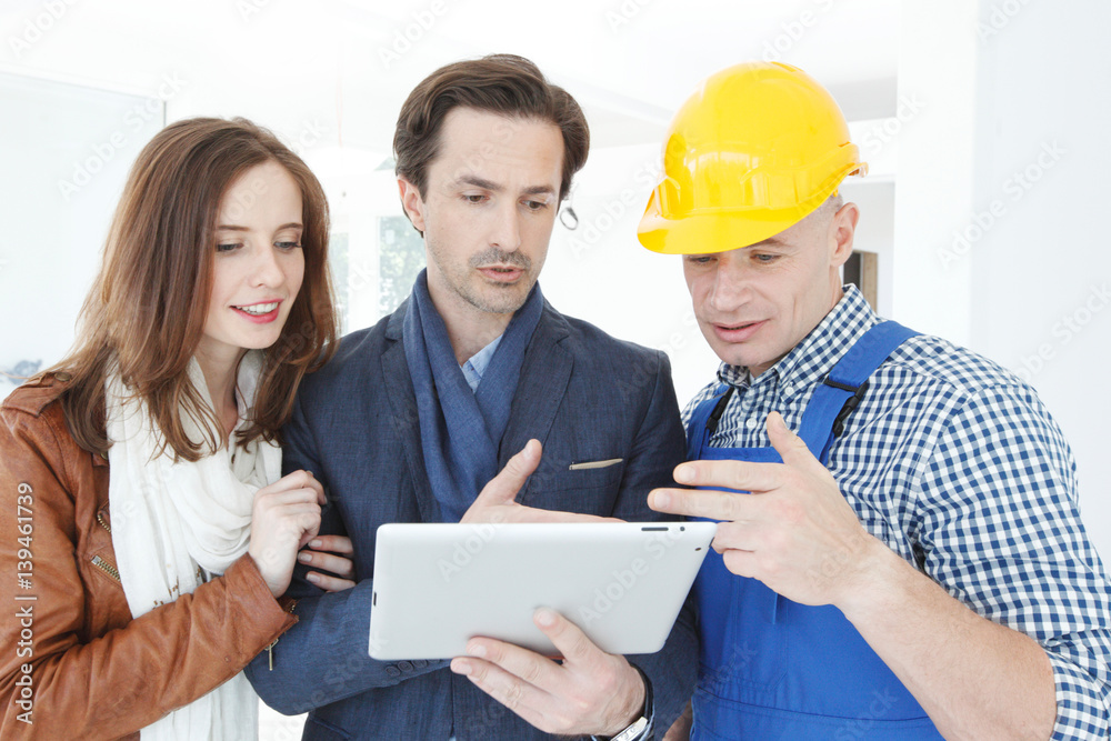 Worker and couple using tablet Worker and couple using tablet