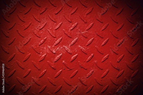 Red metal texture with a pattern in the form of lines and petals, vignetting. Recurring items on the oval metal texture. On top there are few spots of paint and small cracks.