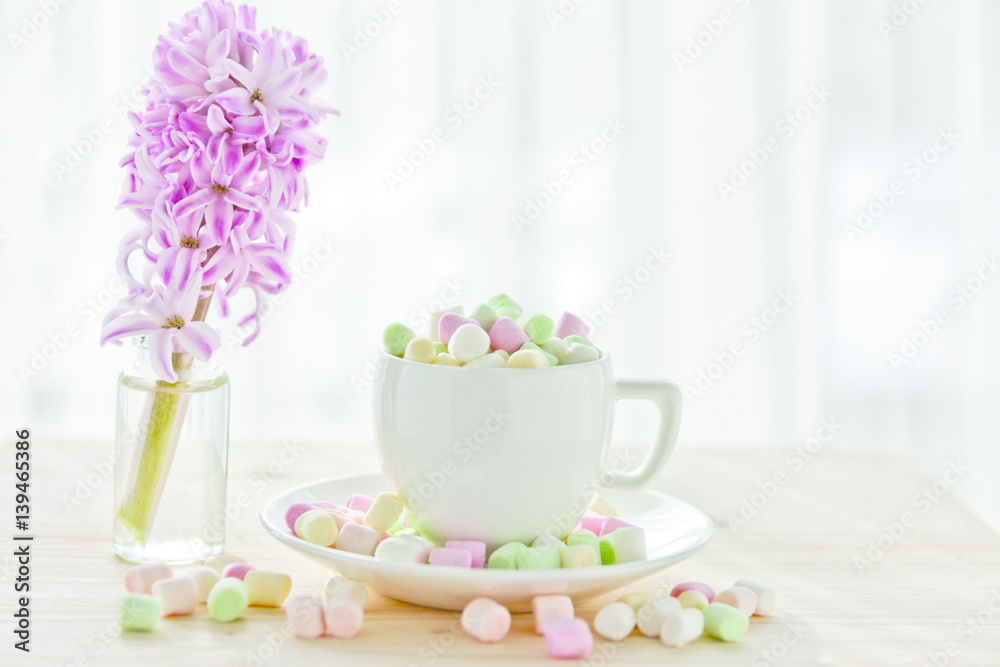 coffee cup with marshmallows and hyacinth on a light background coffee cup with marshmallows and hyacinth on a light background