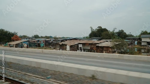 Wallpaper Mural View of railroad tracks from the train window. Passing by Suburb of Bangkok
 Torontodigital.ca