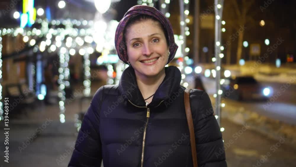 The smiling woman goes on the camera