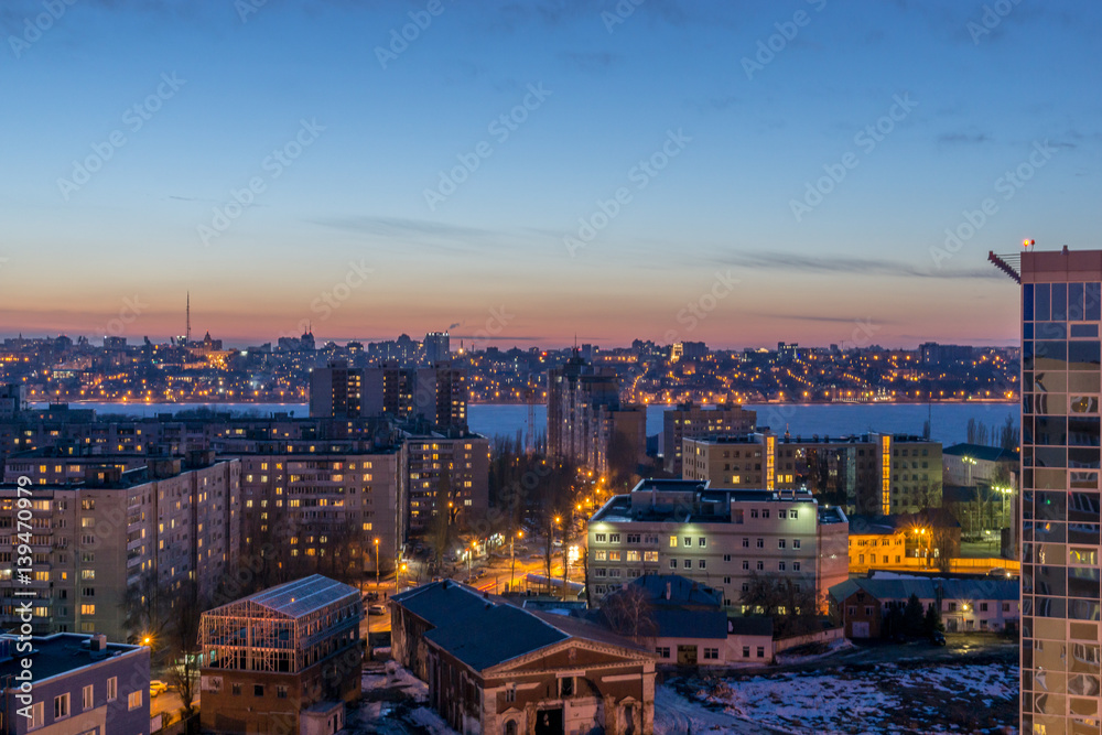 Night Voronezh city after sunset, blue hour, night lights of houses, buildings, 