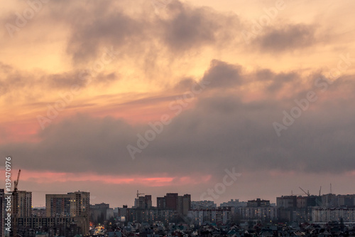 Dramatic aerial sunset cityscape from rooftop of Voronezh city with houses