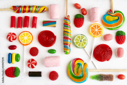 Colorful lollipops and candies and sweet candy of different colors on white background.