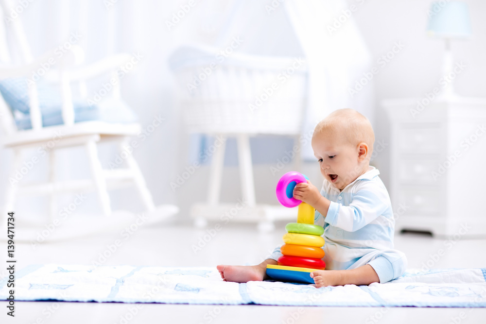 Baby playing with toy pyramid. Kids play Baby playing with toy pyramid. Kids play