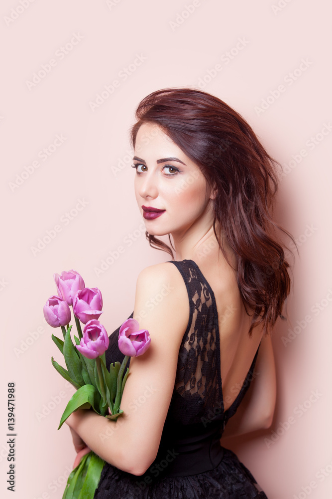 beautiful young woman with bunch of tulips on the wonderful pink background beautiful young woman with bunch of tulips on the wonderful pink background