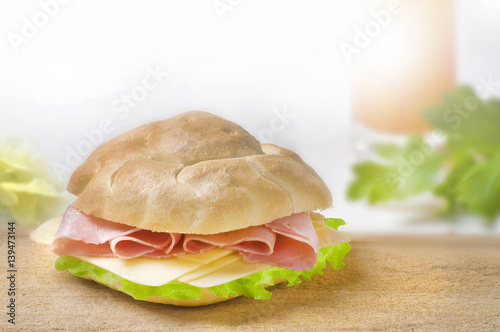 sandwich with ham and green lettuce and cheese