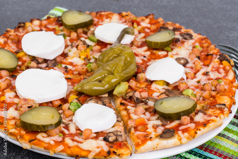 Home pizza with mozzarella and pickled gherkins Home pizza with mozzarella and pickled gherkins