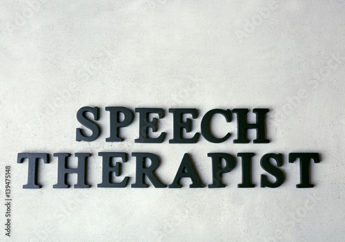 Inscription SPEECH THERAPIST made with  letters on texture background © Africa Studio