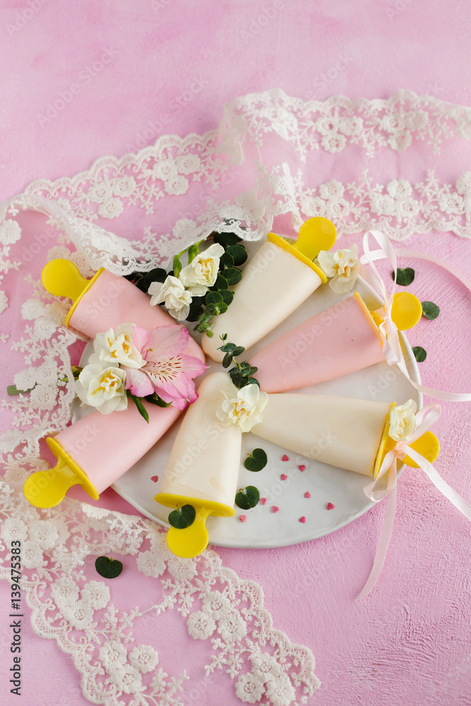 Yoghurt ice cream, decorated with flowers on a pink background Yoghurt ice cream, decorated with flowers on a pink background