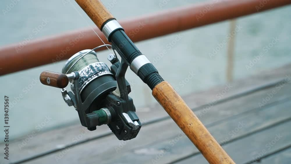 Close up video of a big fishing reel in natural setting.
Close up video of a big fishing reel in natural setting.