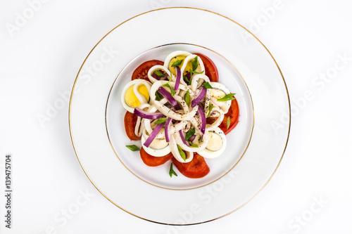 Seafood salad with squid on white background
