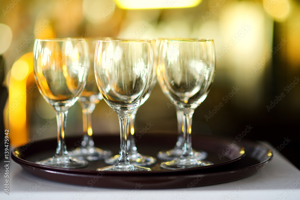 Lots of wine glasses during some festive event Lots of wine glasses during some festive event