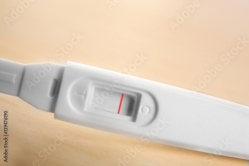 Pregnancy test on wooden background