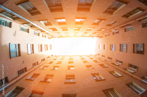 Rectangular closed yard old houses wells in St. Petersburg sky and light photo