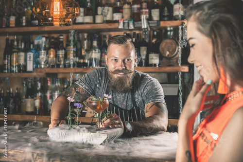 Beautiful girl looking at handsome bartender