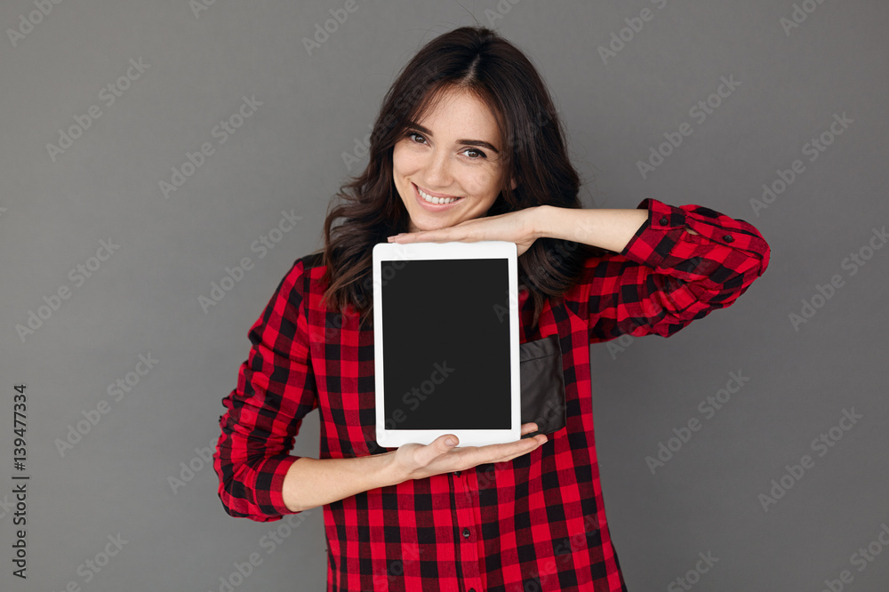 Casual happy Woman Showing Digital Tablet With Blank Screen