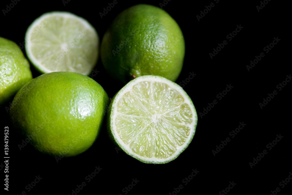 juicy limes on a black background juicy limes on a black background