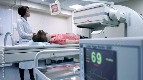 A hospital patient is scanned by the latest medical technology. CT scanner. Radiology equipment.