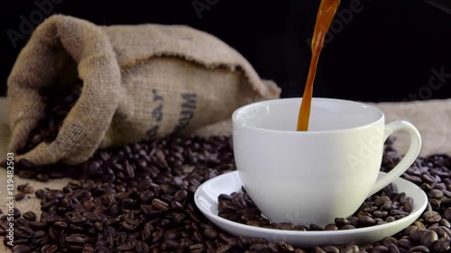 pouring fresh tasty coffee into cup
