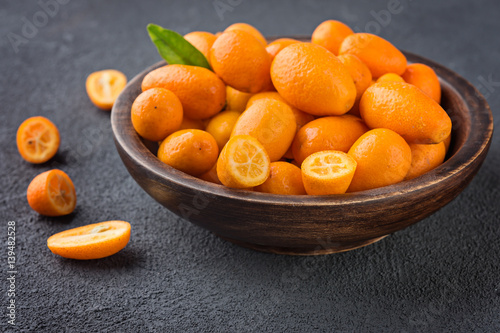 Citrus fruits,   kumquats on wooden bowl,  vitamin food concept
