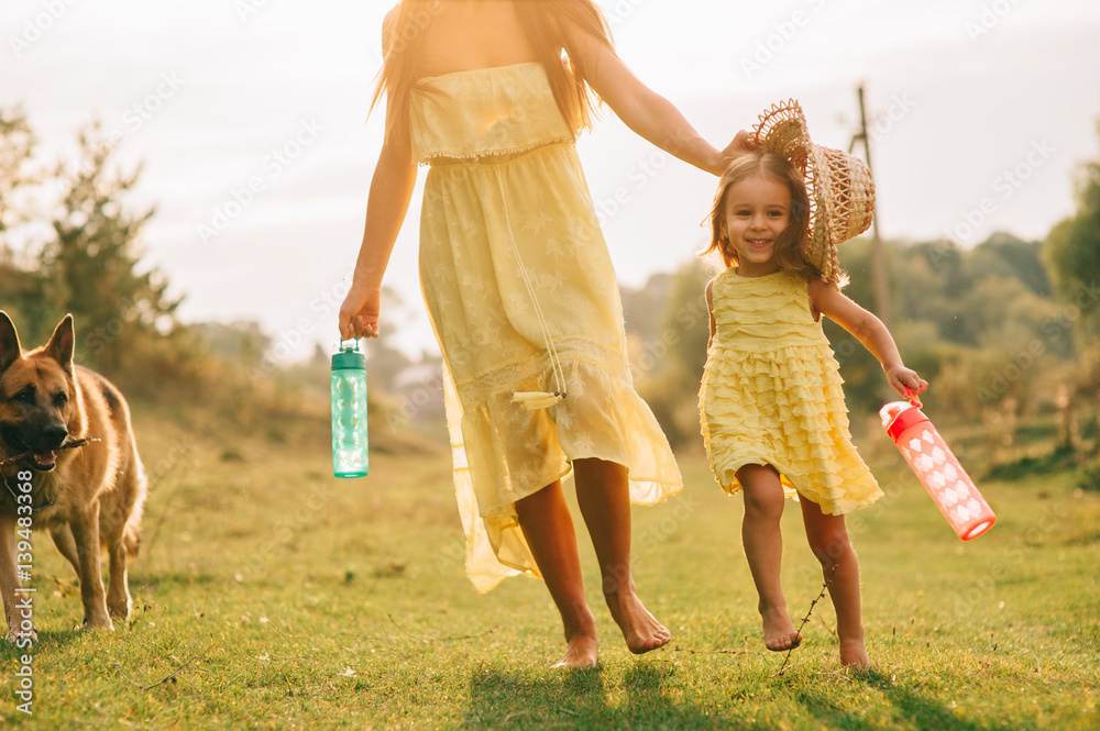 Obraz premium mother walk with his little daughter, and their dog