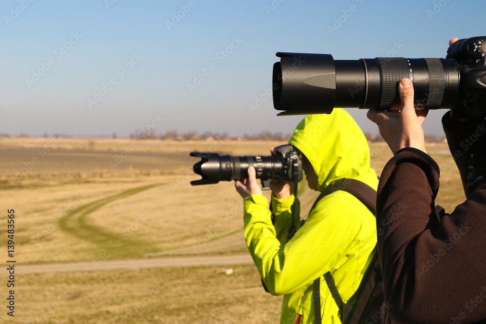 Two paparazzi with long lens