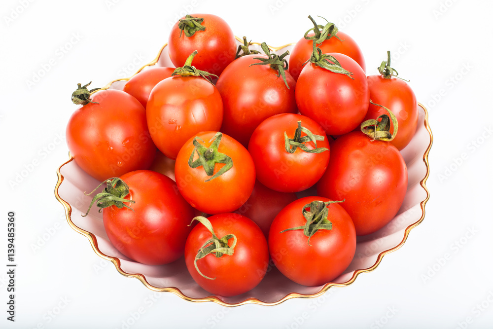 Fresh small tomatoes in white salad bowl