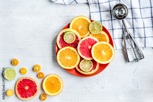 sliced citrus fruits on kitchen background top view mockup