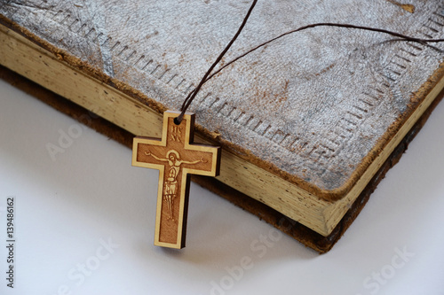 Wooden cross on bible photo