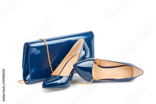 Beautiful blue shoes with clutches on white background