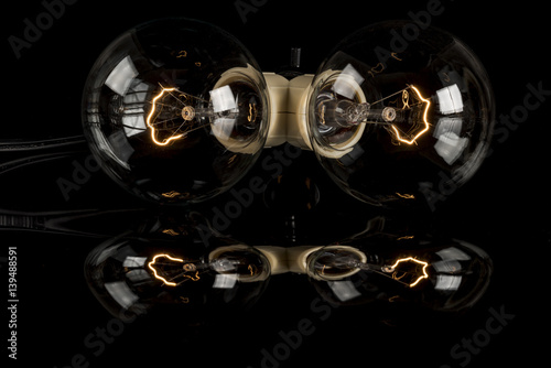 Two fancy lightbulbs with reflection