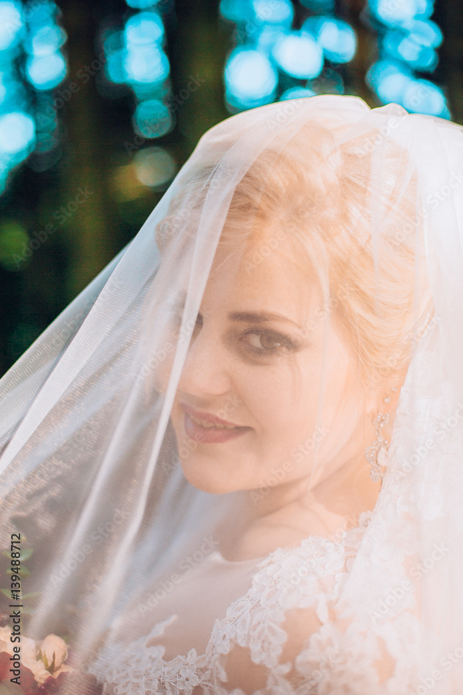 bride portrait under veil in pine forest. bride portrait under veil in pine forest.