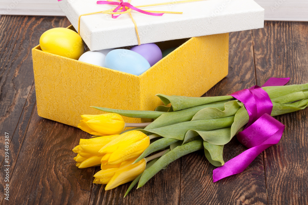 Easter Eggs in a box with colorful tulips Easter Eggs in a box with colorful tulips