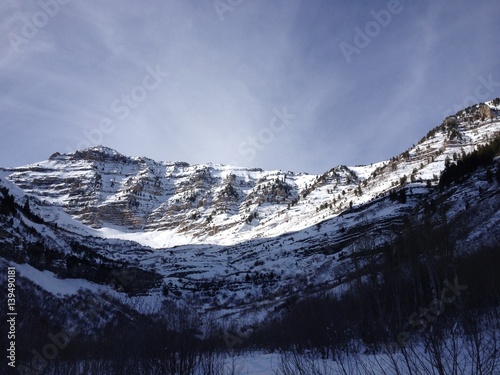 Snow covered Wasatch Mountains, wispy clouds and blue skies on a winter afternoon up Provo Canyon near Sundance Utah.