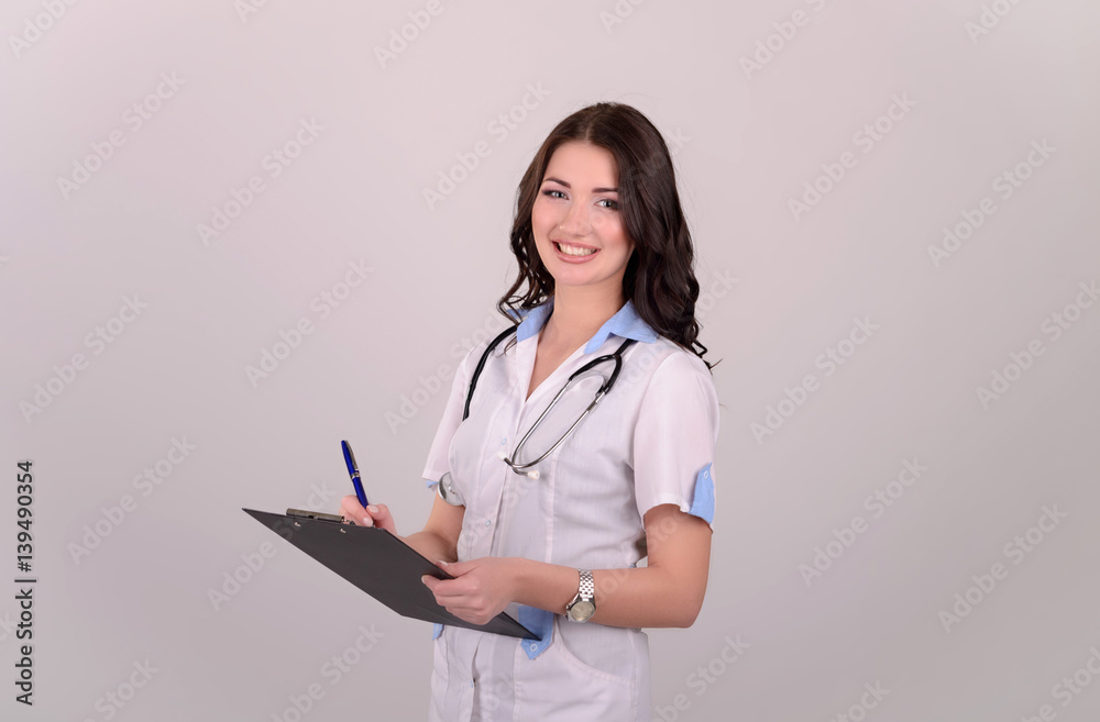 The smiling female doctor in a white dressing gown The smiling female doctor in a white dressing gown