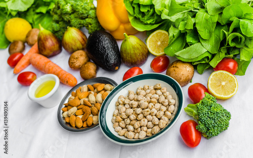 Close up photo of fresh fruit and vegetables, grains, and nuts on a white background. Concept of cooking and eating healthy food, fitness, vegetarian and vegan, and lifestyle. © Aleksandr Vorobev