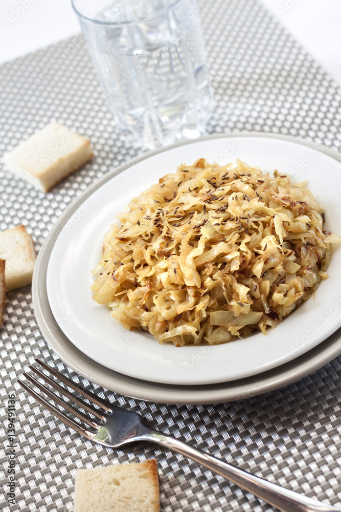 Fried cabbage with caraway and garlic on a plate