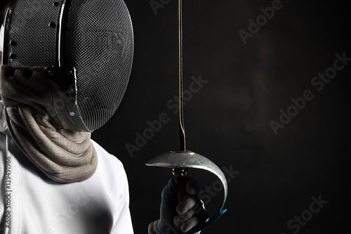 Fotografija Portrait of fencer woman wearing white fencing costume practicing with the sword