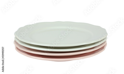 Stack of pink and white fine porcelain plates on white background
