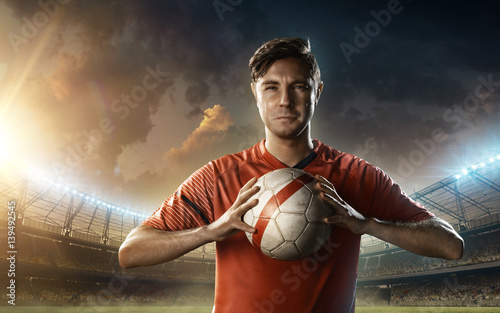 Fotografia, Obraz soccer player on a soccer playground with a ball